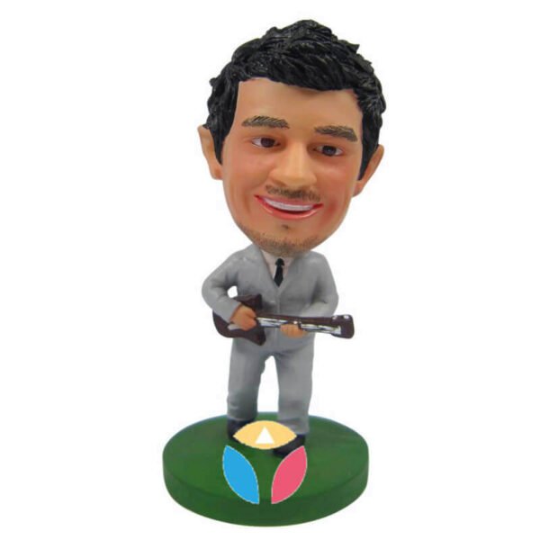 Male in suit palying guitar bobblehead doll
